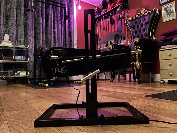 Sex machine and throne in the purple-lit dungeon room
