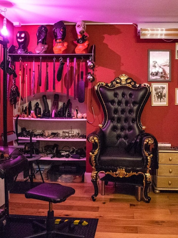 Main dungeon room with throne, stool, toy wall and purple lighting