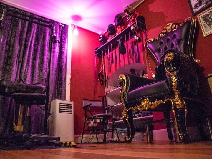 Throne and spanking bench under violet light