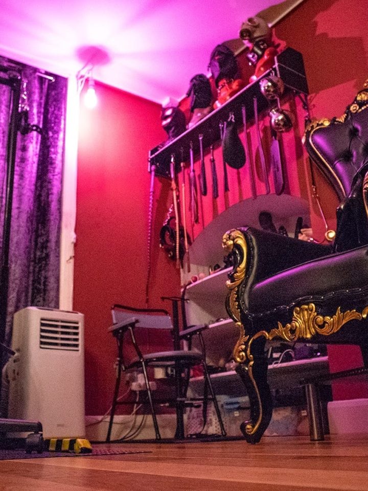 Throne and spanking bench under violet light