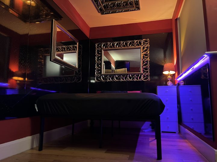 Leather bench and ornate mirror in the dungeon bedroom